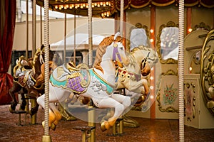 Merry go round carousel with white horse closeup