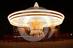 Merry-Go-Round in motion illuminated at night
