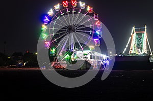 merry go round swing at night with colorful light at city fair ground from different angle