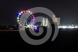 merry go round swing at night with colorful light at city fair ground from different angle