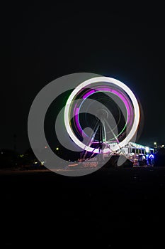 merry go round swing at night with colorful light at city fair ground and long exposure motion burr