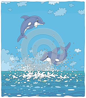 Merry little dolphins flying over waves