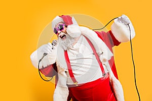 Merry x-mas carols from crazy overweight white hair christmas grandfather hold microphone sing song on noel time