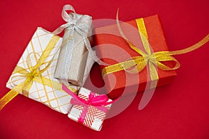 Merry New Year and Merry Christmas 2023 red gift boxes. Close up composition with gifts on red background