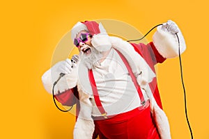Merry x-mas carols from crazy overweight white hair christmas grandfather hold microphone sing song on noel time photo