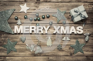 Merry Xmas: christmas greeting card with blue and white decoration on wood.