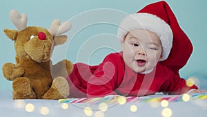 Merry xmas, happy new year, infants, childhood, holidays concept - close-up smiling funny newborn baby in santa claus