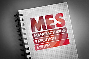 MES - Manufacturing Execution System acronym on notepad, business concept background