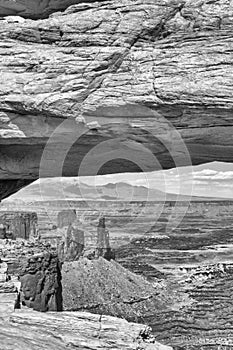 Mesa Arch with Canyonlands National Park landscape on background