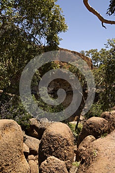 A mesa with boulders and trees in outback Queensland.