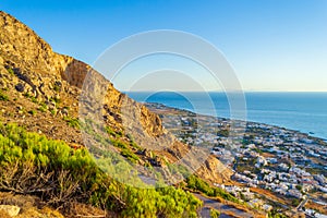 Mesa Vouno mountain and Kamari village at Aegean Sea coast Santorini Greece