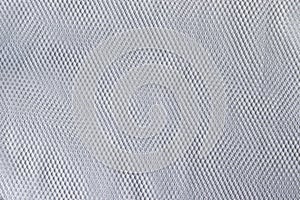 Mesh fabric texture. White textile background. Laundry bag closeup