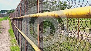 Mesh fencing. Iron fence on a horse farm. The grid of the corral