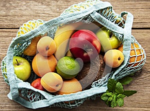 Mesh shopping bag with organic fruits