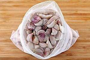 A meshed bag full of Thai garlic photo