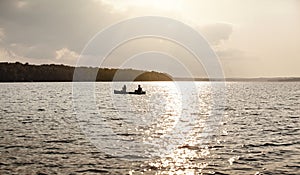 Mesmerised by the view. an unrecognizable couple rowing a boat out on the lake.