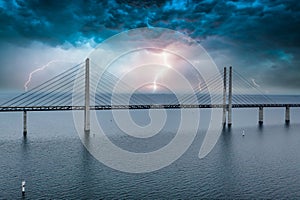 Mesmerizing aerial view of the bridge between Denmark and Sweden under the sky with lightning