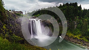 Mesmerizing display of the Snoqualmie Falls waterfall surrounded by green vegetation