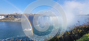 Mesmerizing panoramic view of the double rainbow over the Niagara Falls