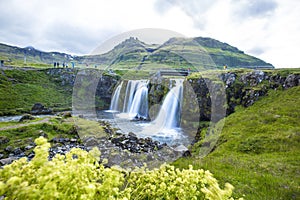 Mesmerizing scenary of a beautiful waterfall in Kirkjufellsfoss mountain in Iceland
