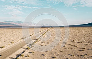 Mesmerizing shot of a huge salt lake with an endless road in the Death Valley