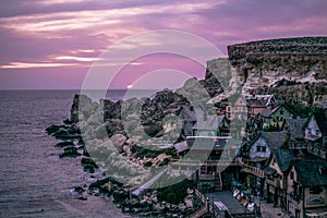 Mesmerizing shot of Popeye Village (Sweethaven Village) during the sunset at the Prajjet Bay, Malta