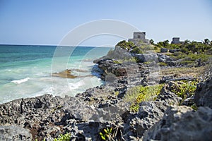 Mesmerizing shot of a rocky cliff by the ocean in Tulum, Mexica photo