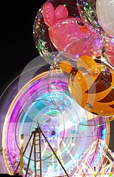 A mesmerizing spectacle unfolds as the Ferris wheel casts vibrant light trails photo