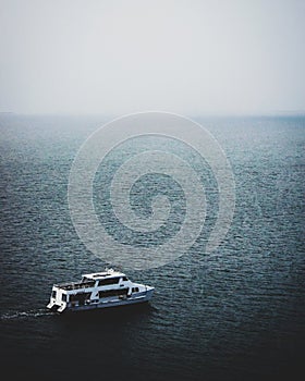 Mesmerizing view of the boat in the calm sea on a foggy day