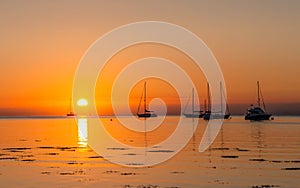 Mesmerizing view of the boats sailing on Isle of Arran at sunrise