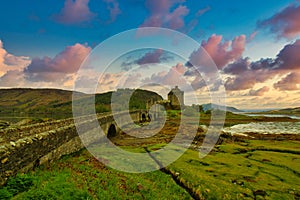 mesmerizing view of Eilean Donan Castle in Loch Duich, Scotland during sunset