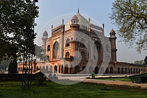 A mesmerizing view of safdarjung tomb memorial and dustbin from the side of lawn at winter morning