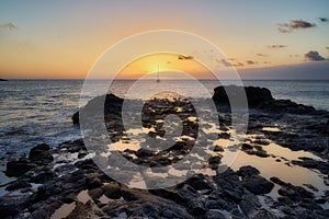 Mesmerizing view of the sunset over the rocky seashore