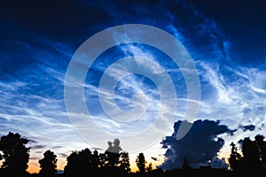 Mesospheric clouds in the darkening evening sky, a rare natural phenomenon, soft focus