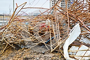 A mess at a construction site with scattered building materials and rubbish with dirt, poor safety precautions, unsanitary