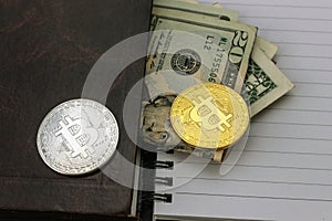 Mess on your desktop. Calculator, notebook, documents, Bitcoin, USD, paper money