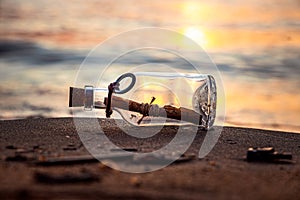 Message in the bottle against the Sun setting down