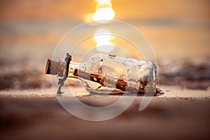 Message in the bottle against the Sun setting down