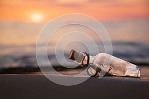 Message in the bottle against the Sun setting down