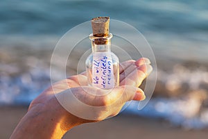 Message in a bottle with the inscription: we will definitely return