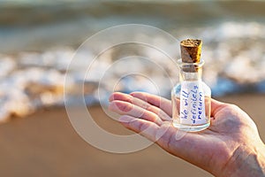 Message in a bottle with the inscription: we will definitely return with copy space