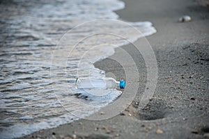 Message in the bottle rolling in waves