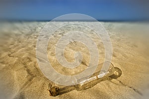 Message in a bottle in the sand of the beach