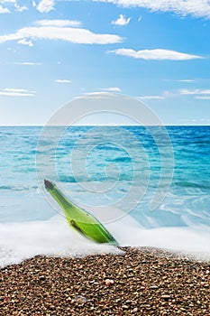 Message in bottle on sea beach