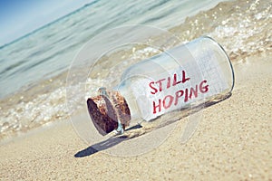 Message in a bottle Still hoping on sandy beach.