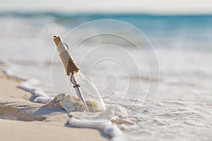 Message in a bottle on a tropical beach and blurred background. Inspire background design