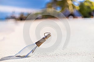 Message in a bottle on a tropical beach and blurred background. Inspire bckground design