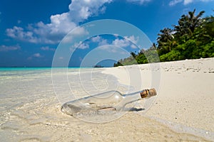 Message in a bottle washed ashore on a tropical beach