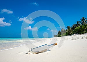 Message in a bottle washed ashore on a tropical beach