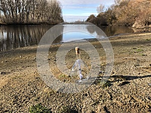 Message in a crystal bottle in the beach with water and sand